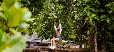 woman sitting on a swing in the jungle of Costa Rica