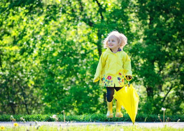 Blond Toddler Girl Yellow Raincoat Jumping — Stockfoto