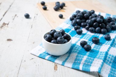Blueberries on in a small bowl on a wooden table