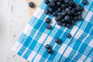 Top view of blueberries on tablecloth with blue pattern