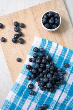 Top view of blueberries on wooden cutting board
