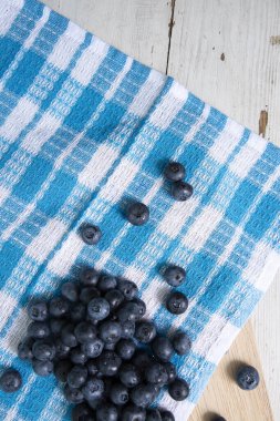 Top view of blueberries on tablecloth with blue pattern