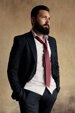 Attractive young bearded man in a suit