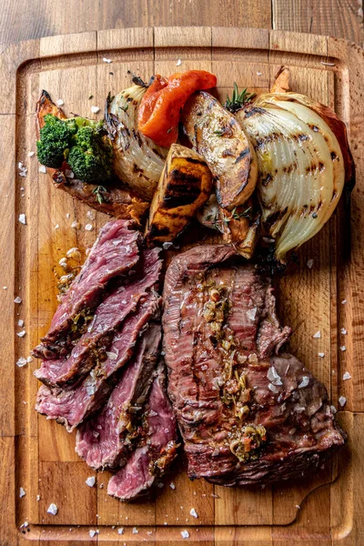 Argentine cut of meat called Vacio with chorizos and chimichurri.