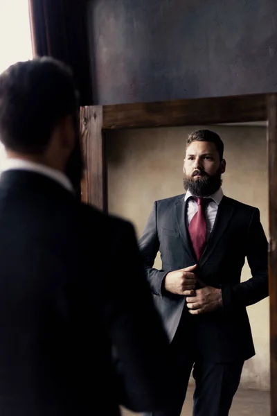 Attractive Young Man Beard Adjusts His Suit Mirror — Stockfoto