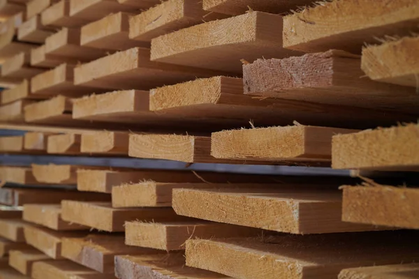 Piles of sustainable wooden planks at a factory
