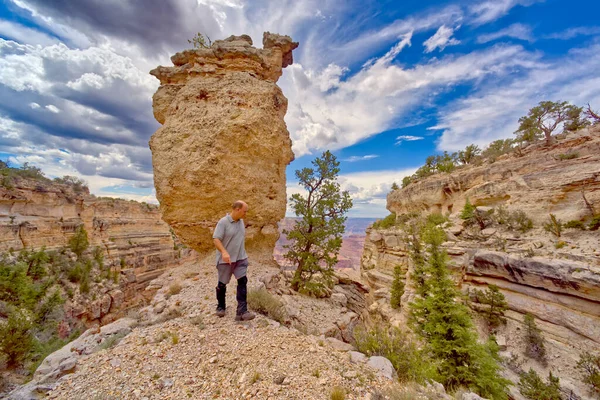 Hiker at the base of Loki\'s Rock at Grand Canyon AZ