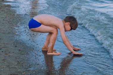 kid playing at the lake