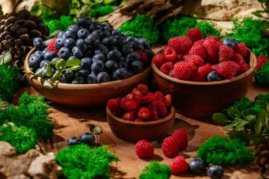 wild berries in a clay plate in a forest clearing.