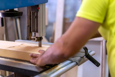 master carpenter cutting wood in his workshop