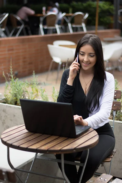 Pretty girl working on laptop outdoor. Business woman working outdoor.
