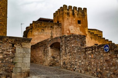 Castle tower on beige stone walls