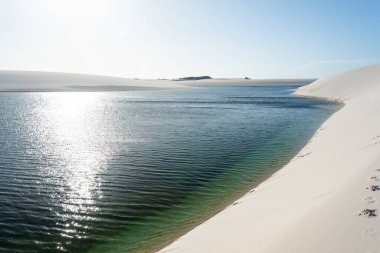 Beautiful view to blue rainwater lagoon and white sand dunes