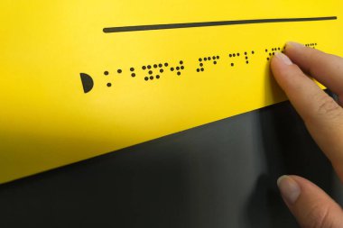 Woman hand reading braille text
