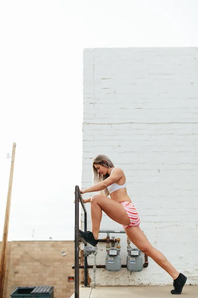 Young Female Woman Stretching Legs Bar White Brick — стоковое фото