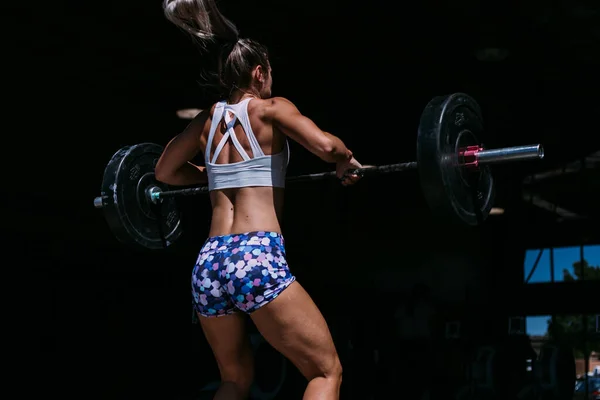 Fit Female Doing Clean Barbell Dark Gym Bac — Stockfoto