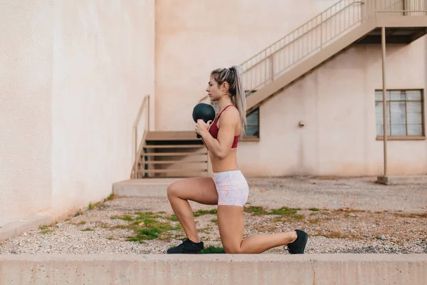 Blonde Woman Doing Kettlebell Lunges Old Building — стоковое фото