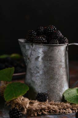 Fresh blackberries in a metal cup