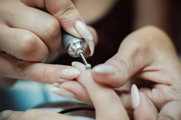 Making manicure with Professional Electric Nail File Drill