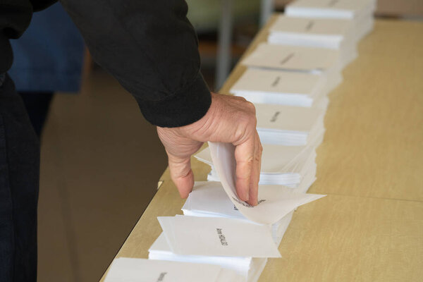 Man Picks Up His Ballot Paper Before Casting His Vote