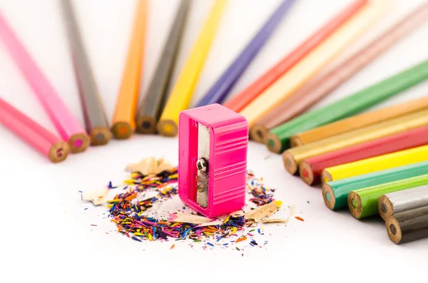Pink sharpener arounded with pencil — Stock Photo, Image