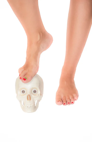 A woman's foot on a skull — Stock Photo, Image