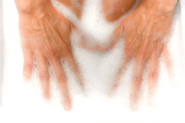 Woman's hands into foam bath — Stock Photo, Image