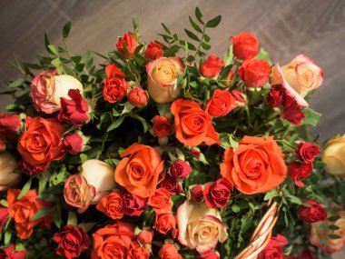 Bouquet of red, orange and yellow roses- a composition of multi-colored flowers. Background for a postcard.