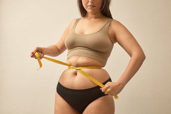 Woman Excess Weight Make Waist Tape Measure Warm Tones Studio Stock Photo