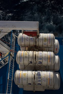 evocative image of the lifeboats of a scheduled ferrywhile browsing