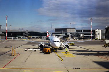 Havaalanının geri kalanında yolcu bekleyen bir uçağın canlandırıcı görüntüsü. 