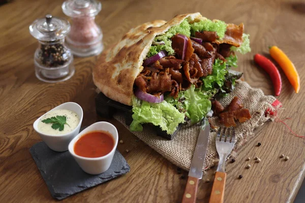 delicious meat doner on the serving plate and salad on the side