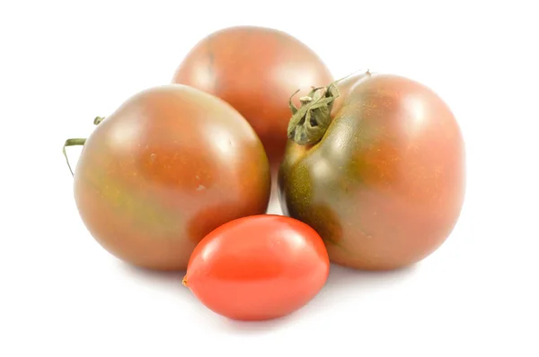 Kumato tomatoes and cherry tomatoes — Stock Photo, Image