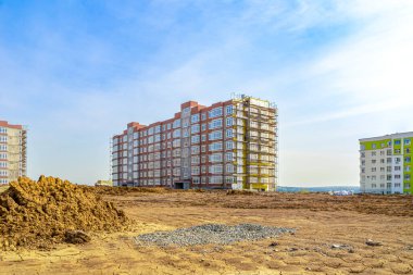 Completion of the construction of an apartment building, insulation and final finishing of the facade of an apartment house, selective focus