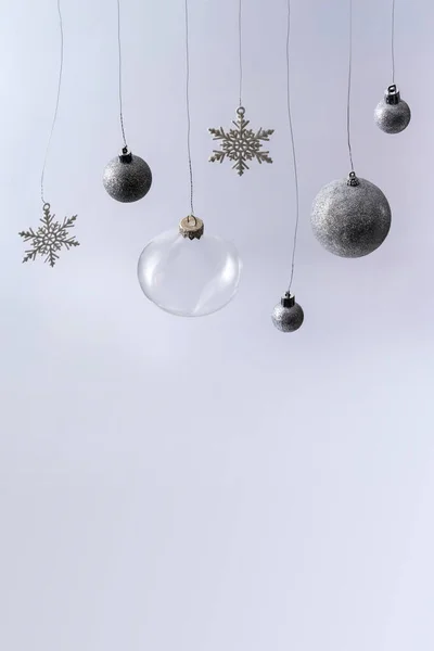 Christmas background from balls and snowflakes hanging from ribbons. — Stock Photo, Image