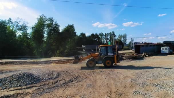 Heavy equipment in construction industry. Yellow excavator on construction site — Stockvideo