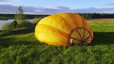 Hot air balloon is a lighter-than-air aircraft. Bag, which contains heated air lies on ground. Envelope is made from nylon fabric. Balloon is inflated using a burner cases by burning liquid propane.