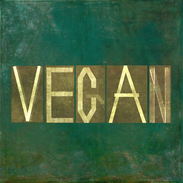 Jordnära bild och design bakgrundselement som skildrar ordet "vegan" — Stock fotografie