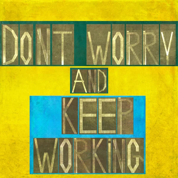 Words "Don 't worry and keep working " — стоковое фото