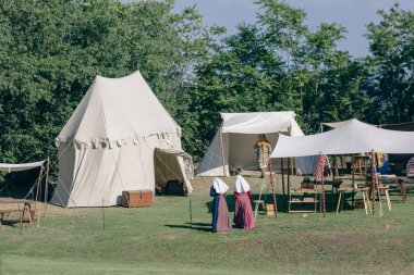 MONTORIO, VERONA, ITALY, 2022: MEDIEVAL FESTIVAL AT THE CASTLE: two women among the tents