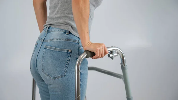 A woman is walking with a walker on a white background — Stock Photo, Image
