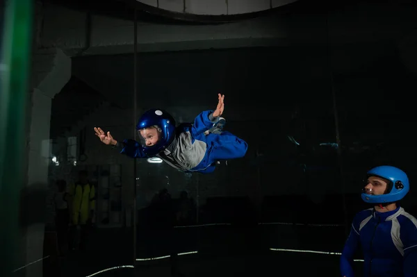 Un uomo insegna a un ragazzo a volare in una galleria del vento. — Foto Stock