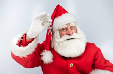 Beyaz arka planda Noel Baba 'nın anahtarları var. Noel için yeni ev hediyesi.