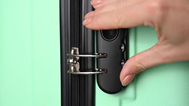 The woman opens the combination lock on the suitcase. Protection of baggage contents during transportation. — Stock Video