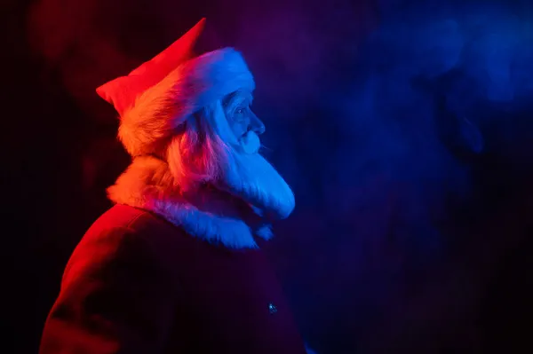 Santa claus in neon light on a black background. Christmas party. — Stock Photo, Image