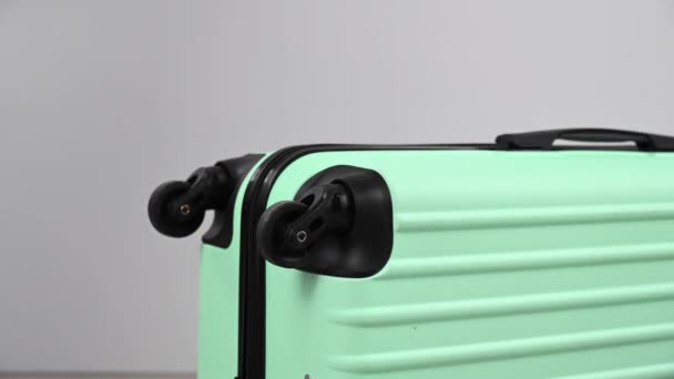 A woman hits a suitcase with a hammer on a white background. — Stock Video