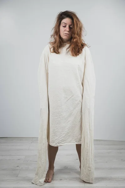 Nahaufnahme Porträt einer wahnsinnigen Frau in Zwangsjacke auf weißem Hintergrund. — Stockfoto