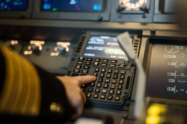 Pilota donna che inserisce le informazioni di volo nel sistema aereo. Pannello di controllo aereo. — Foto Stock