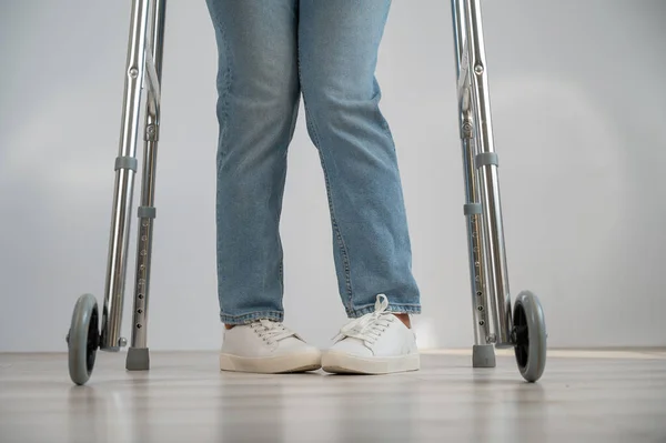 Close-up of female legs with walkers. The girl walks with the help of special equipment. — Stock Photo, Image