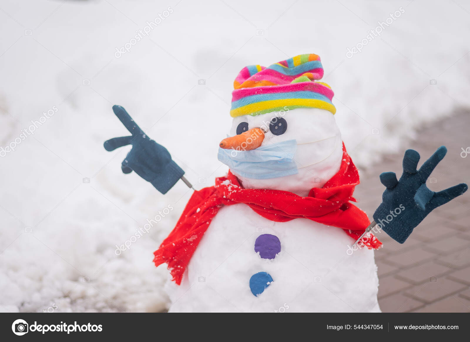 Snowman In A Rainbow-Colored Hat And A Medical Mask. Stock Photo.